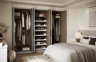 A large fitted wardrobe with the doors open and clothes and shoes visible