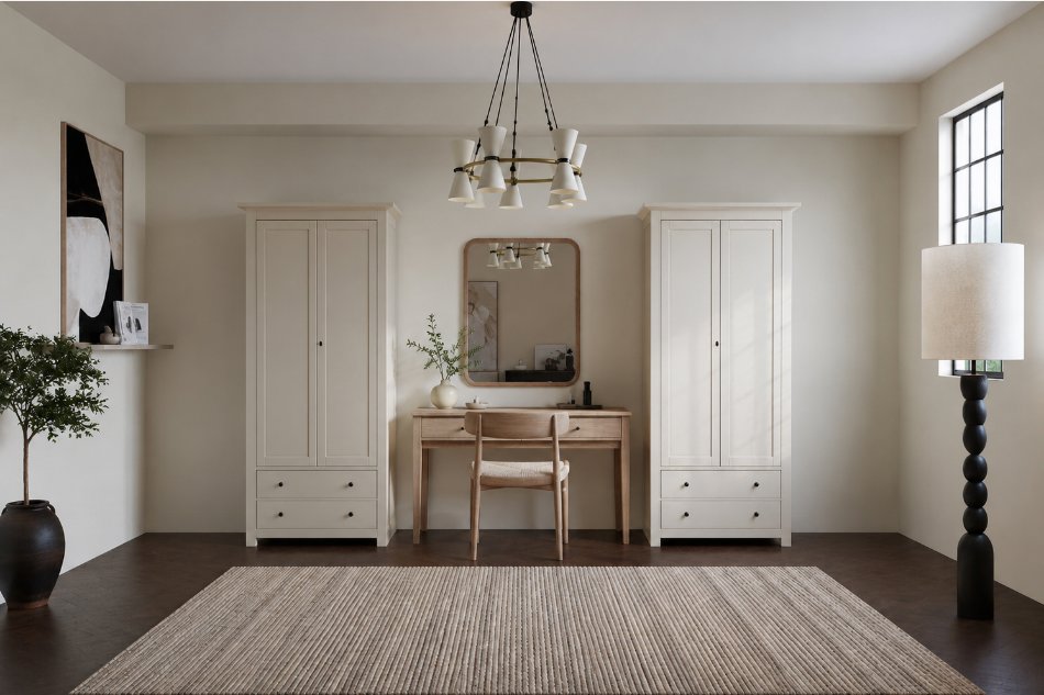 Two free standing white wardrobes with a table and mirror in between