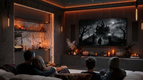 Family watching spooky film in an autumnal living room.
