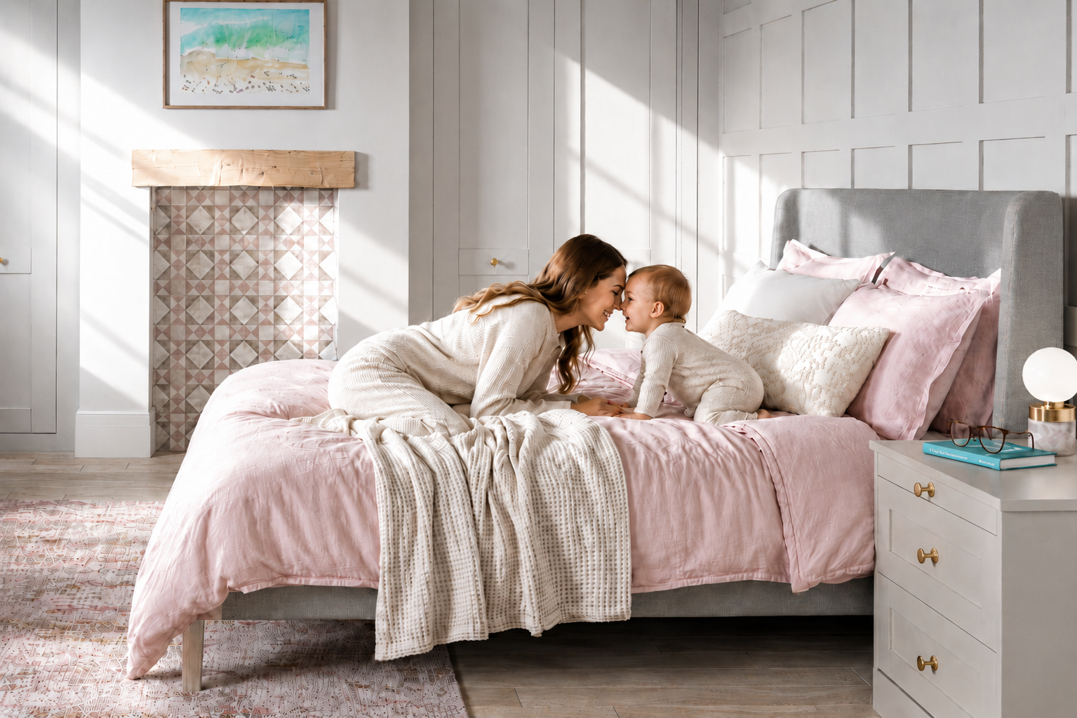 A mother and child in a bedroom with a pink duvet