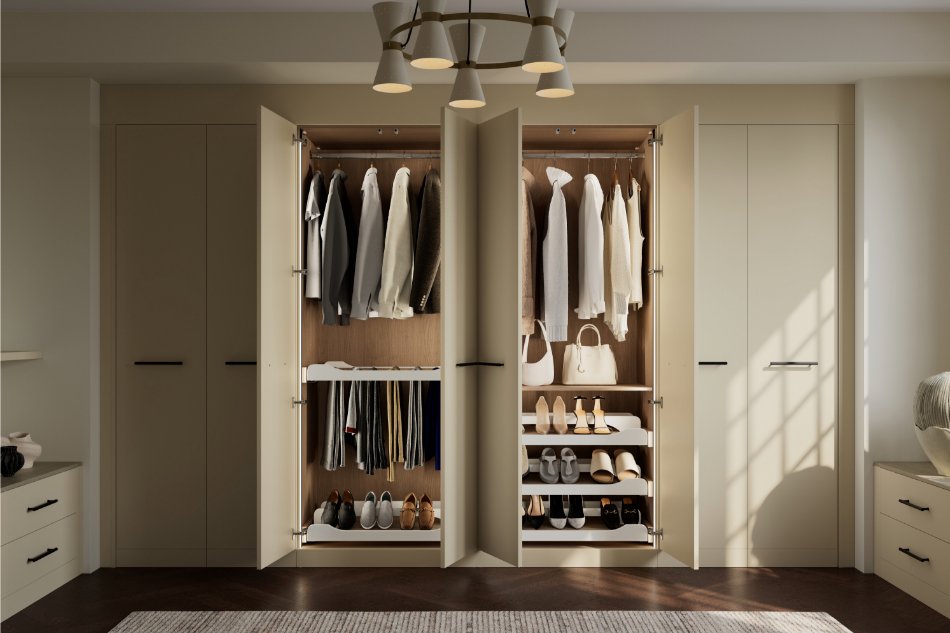 A fitted cream wardobe with the middle two doors open 