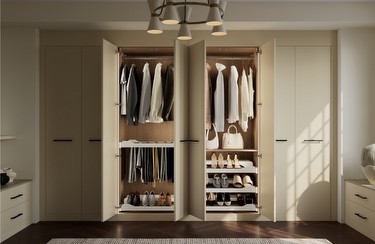A fitted cream wardobe with the middle two doors open
