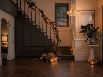Cosy autumnal hallway with dark brown fitted storage.