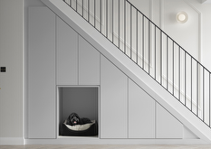 Contemporary light grey understairs storage design
