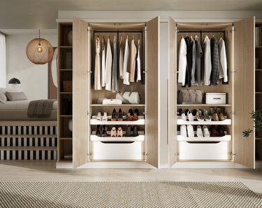 bedroom with white fitted wardrobes and stairs up to the double bed